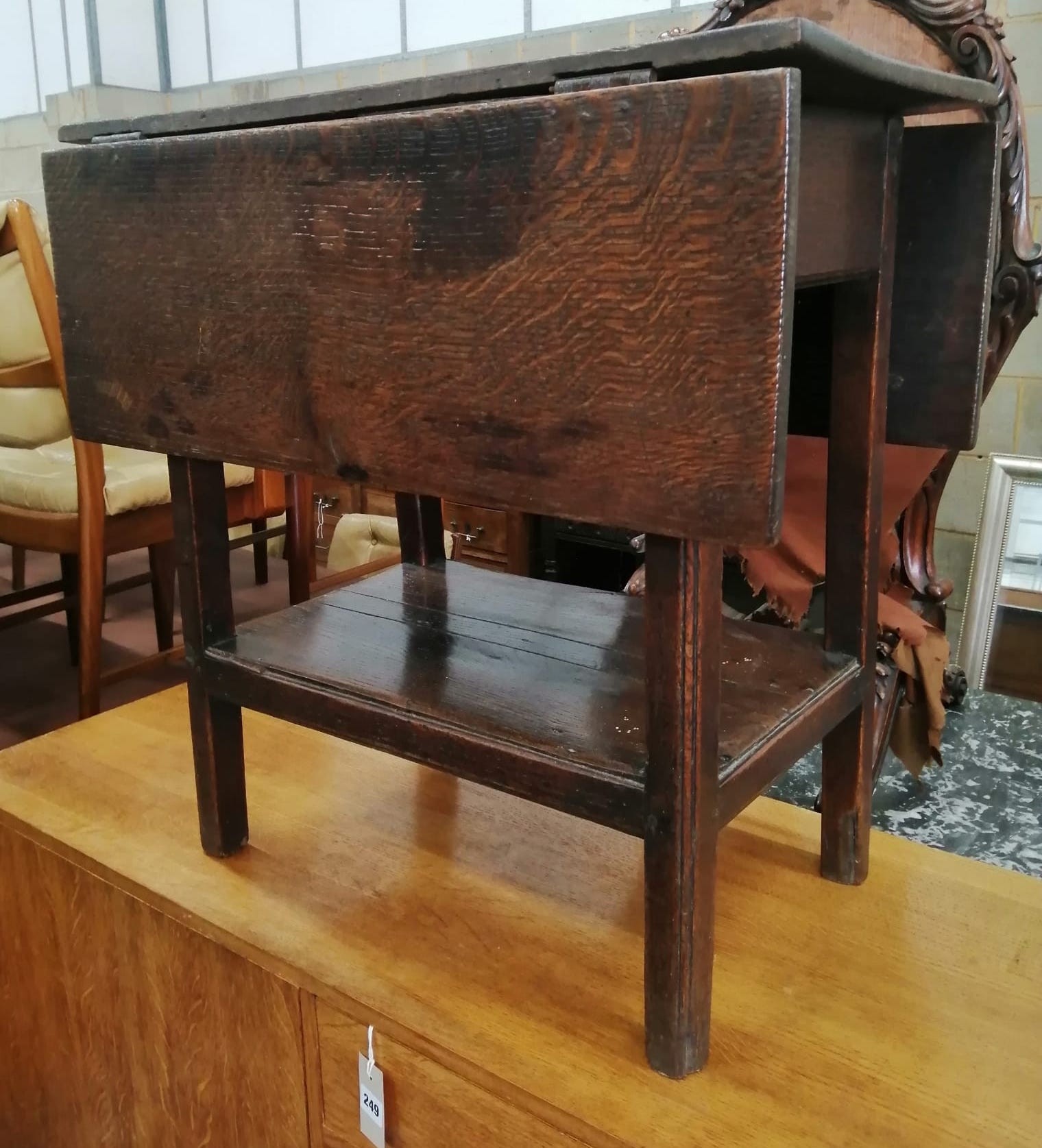 An 18th century oak drop flap two tier table *Please note the sale commences at 9am.